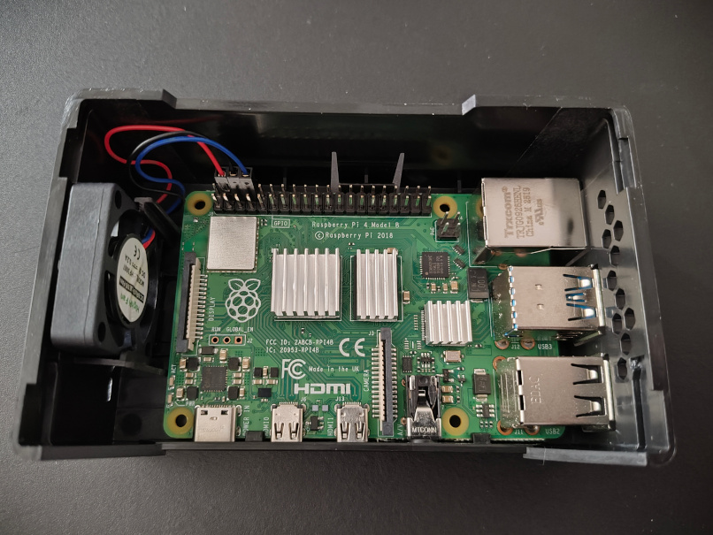 Photo of Raspberry Pi in case with fan pins connected.